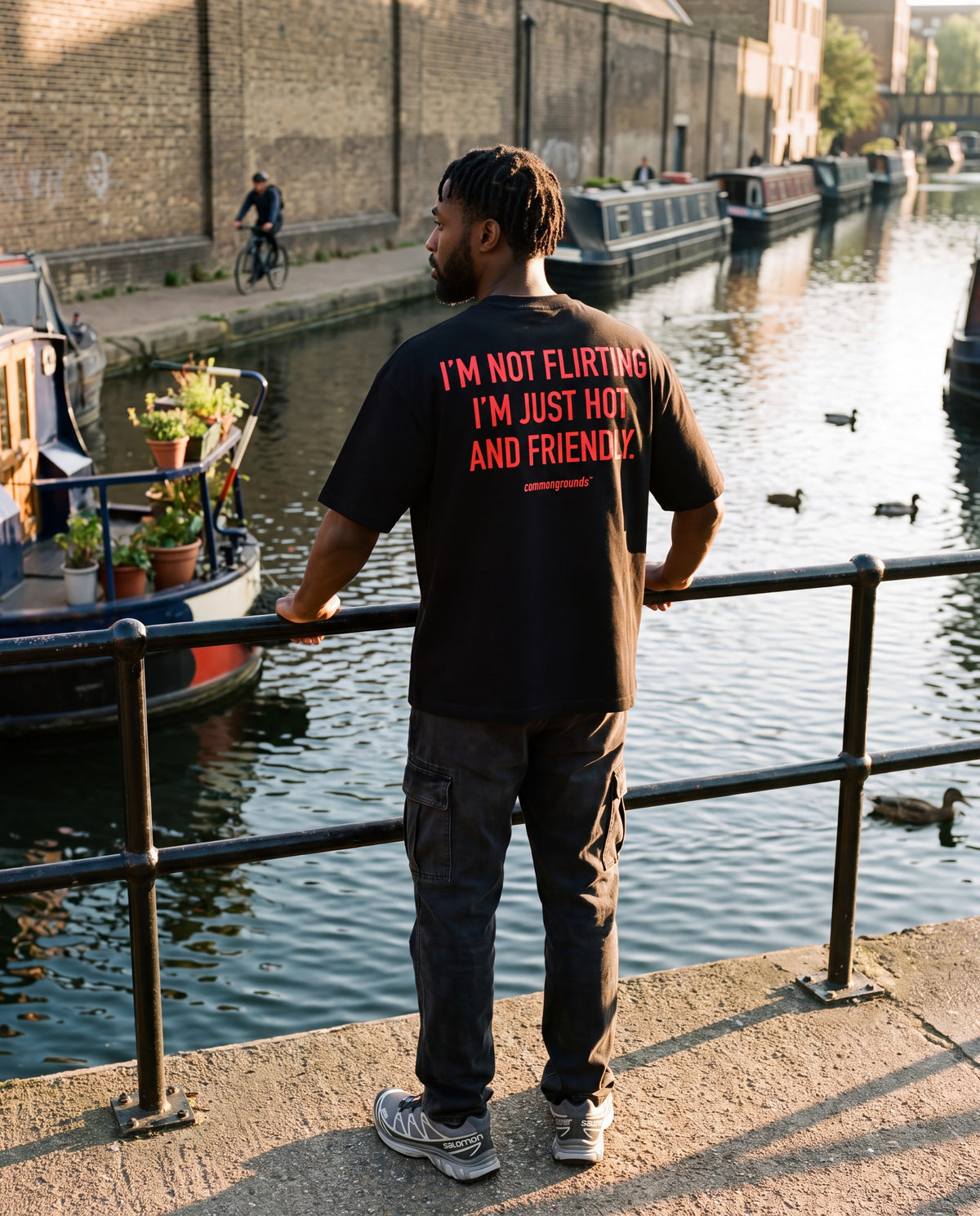 I'M NOT FLIRTING I'M JUST HOT AND FRIENDLY. Tee in black, worn