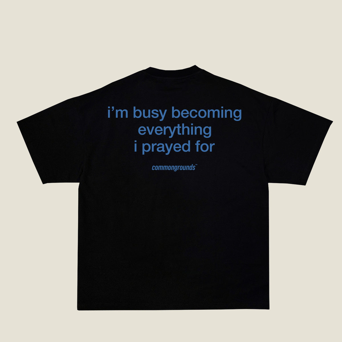 I'M BUSY BECOMING EVERYTHING I PRAYED FOR Tee in black, back print