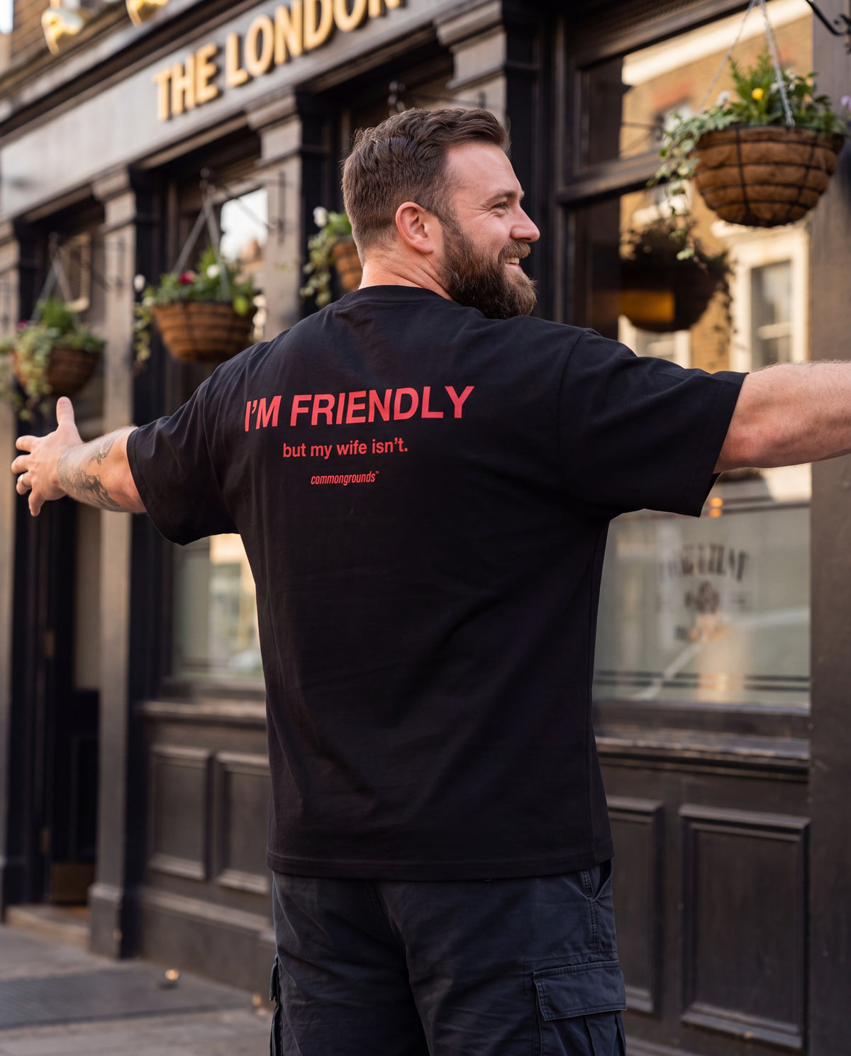 I'M FRIENDLY, BUT MY WIFE ISN'T Tee in black, worn