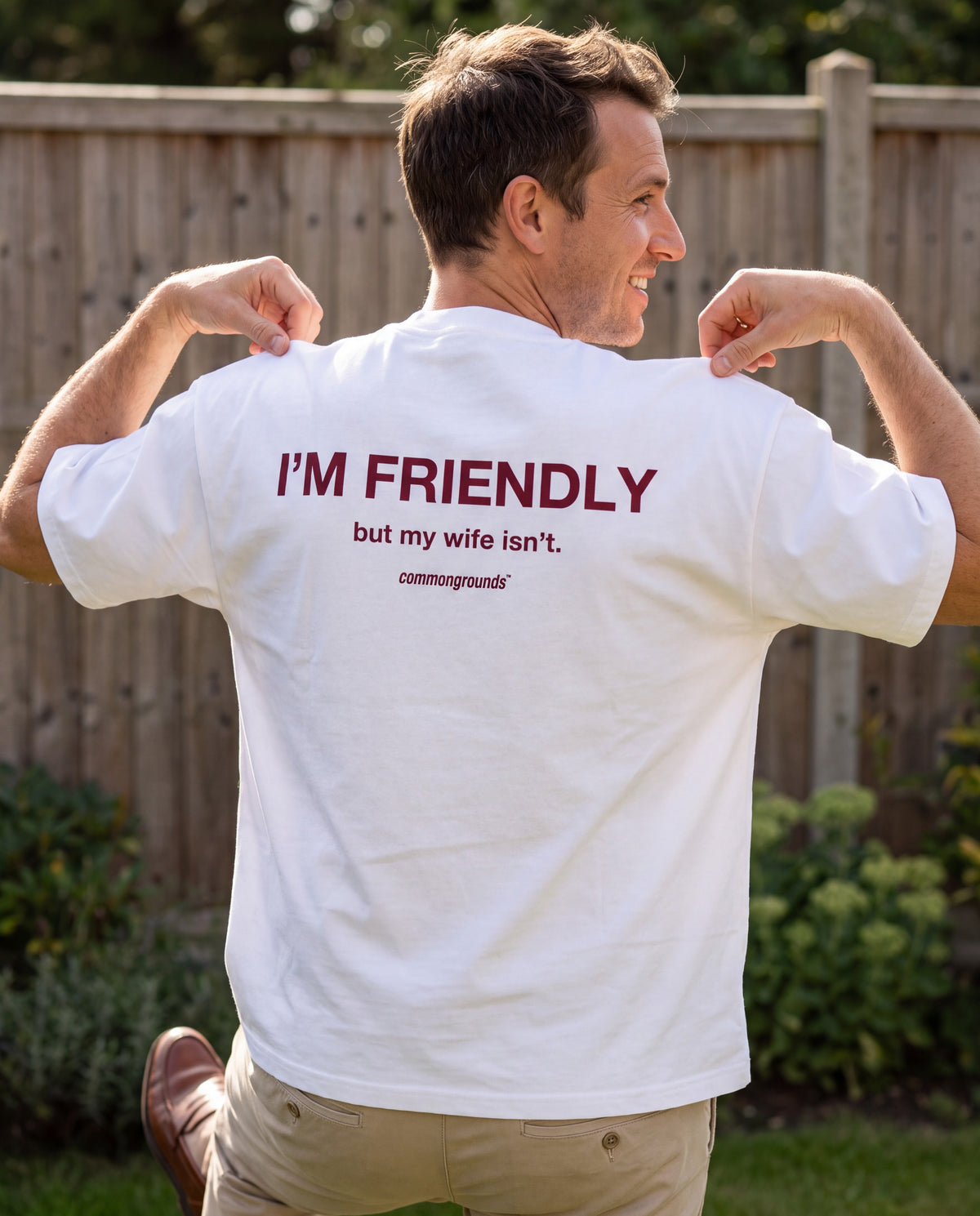 I'M FRIENDLY, BUT MY WIFE ISN'T Tee in white, worn