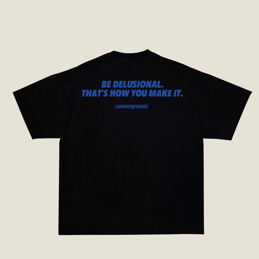 BE DELUSIONAL. THAT'S HOW YOU MAKE IT Tee in black, back print