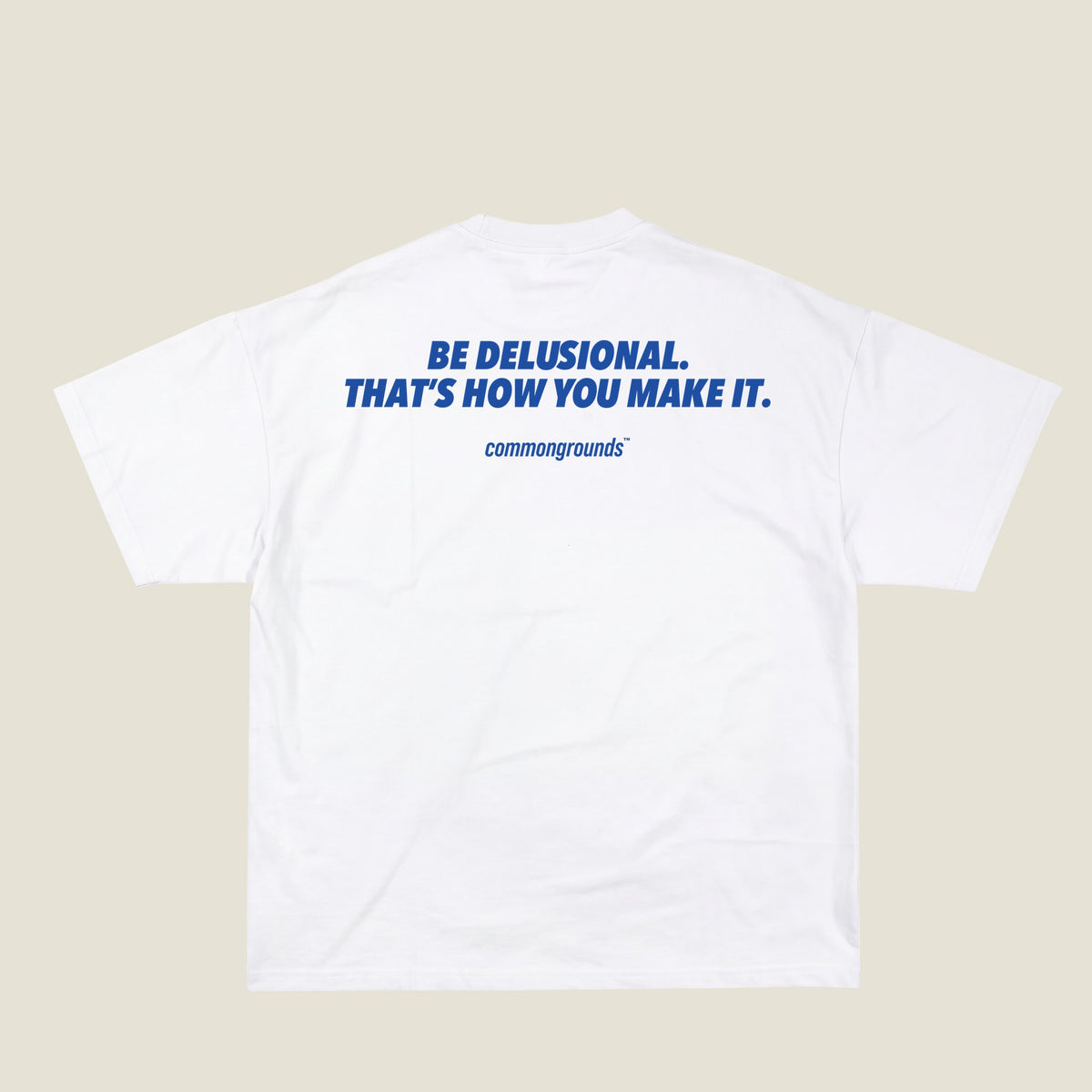 BE DELUSIONAL. THAT'S HOW YOU MAKE IT Tee in white, back print
