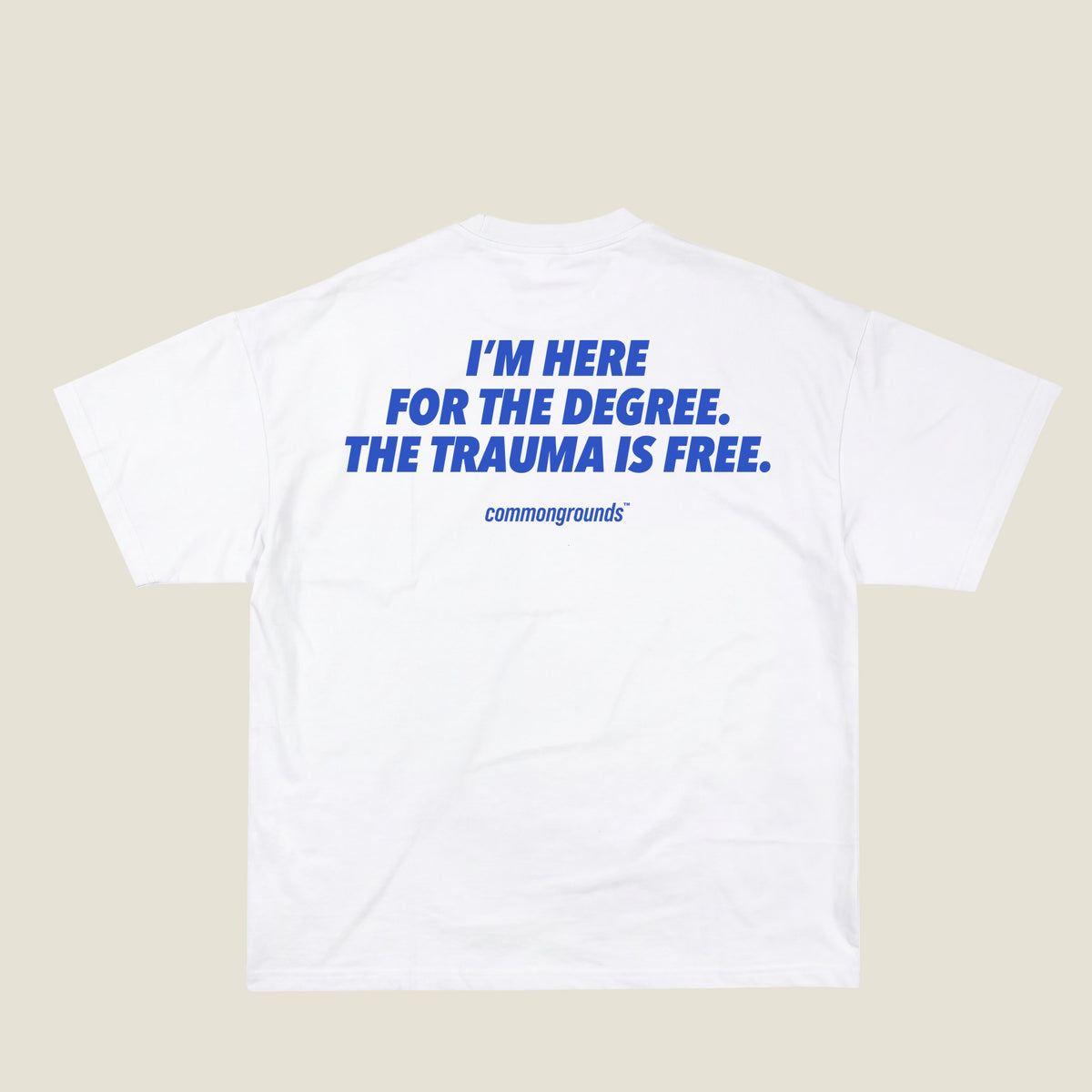 I'M HERE FOR THE DEGREE. THE TRAUMA IS FREE Tee in white, back print