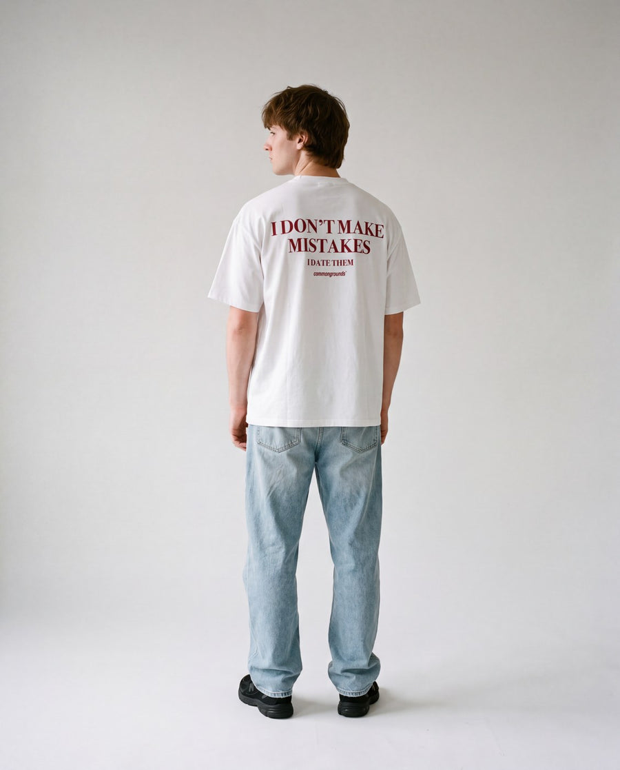 Man in a Common Ground tee against a studio wall